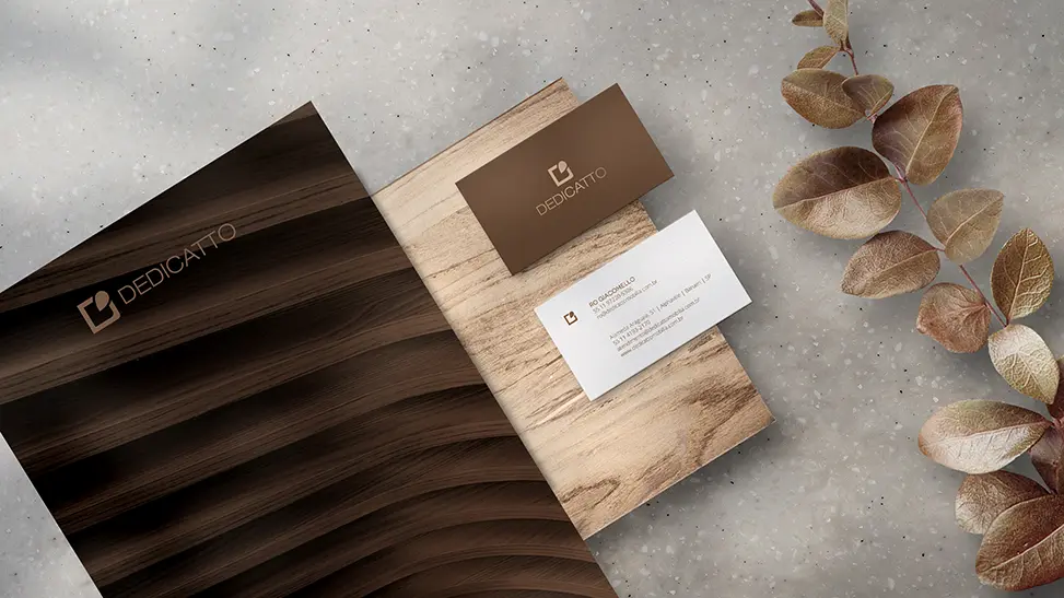 Dedicatto brand system: stationery and materials in warm wood tones that translate the company's essence